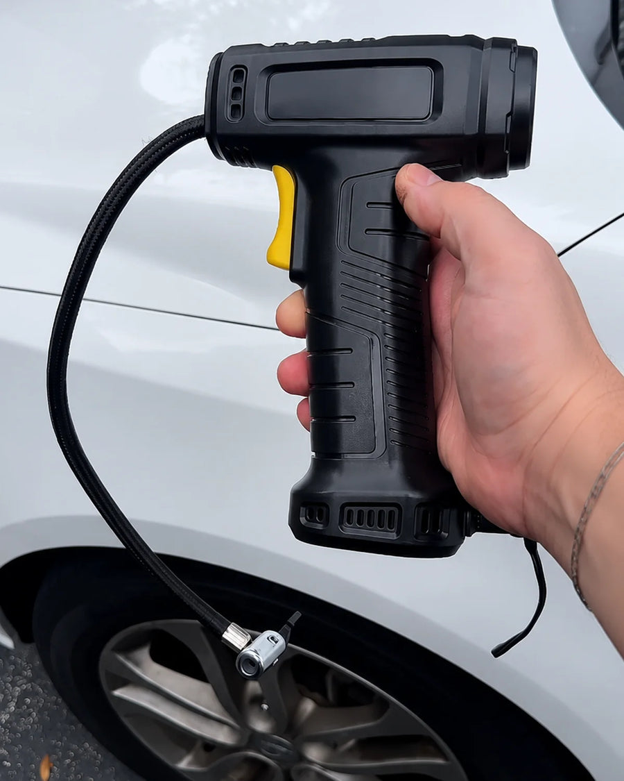 UGC photo - Handheld cordless tire inflator beside a car