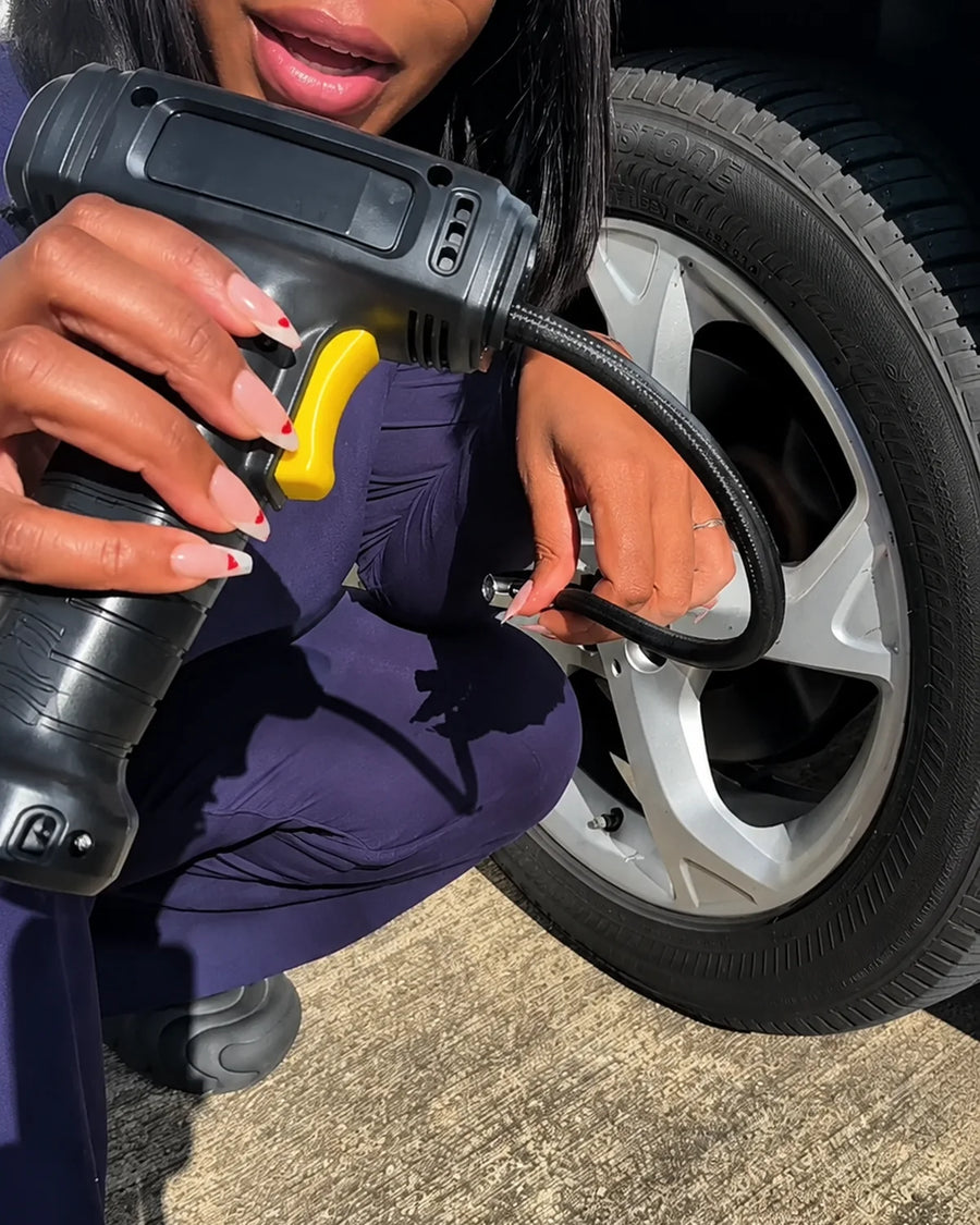 UGC photo - Creator connecting cordless inflator beside a car tire